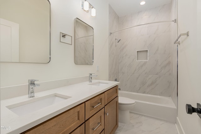 full bathroom featuring tiled shower / bath, toilet, and vanity