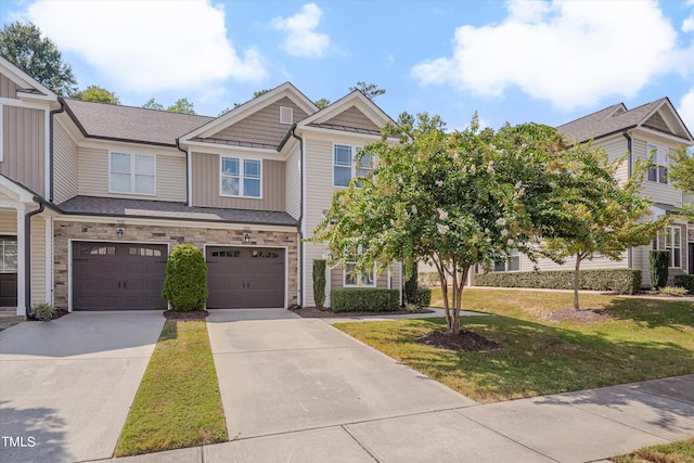 view of front of property featuring a front yard and a garage