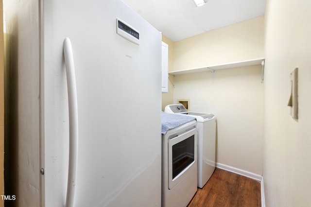 laundry area with dark wood-type flooring and washer and clothes dryer