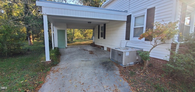 view of home's exterior featuring central air condition unit and a carport