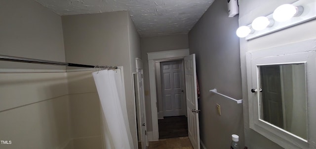 hallway with a textured ceiling