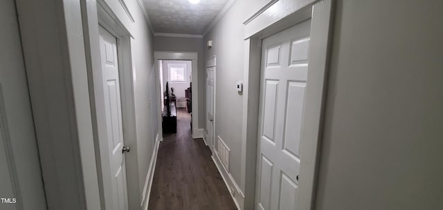 corridor with dark wood-type flooring and ornamental molding