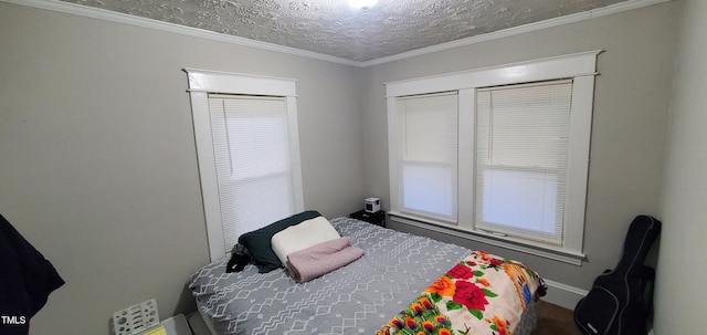 bedroom with crown molding and a textured ceiling