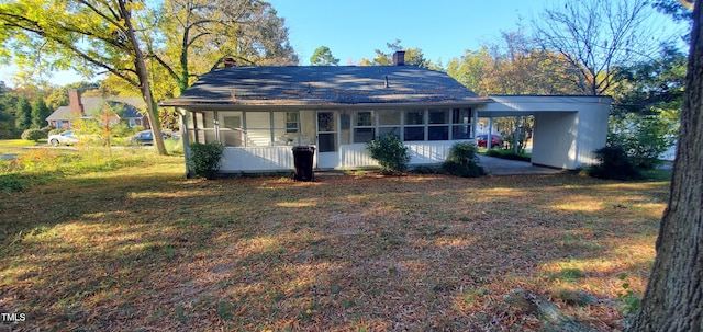 ranch-style house with a carport, a porch, and a front lawn