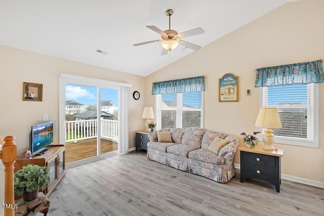 living room featuring light wood-type flooring, vaulted ceiling, and ceiling fan