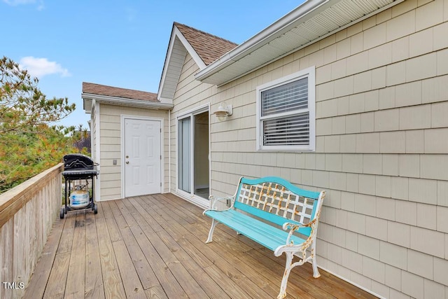 wooden terrace featuring a grill