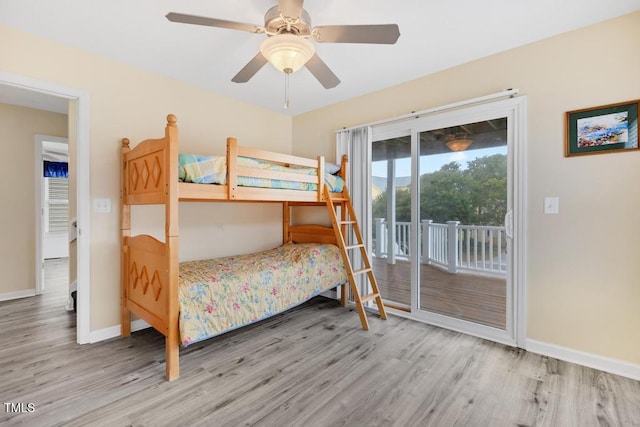 bedroom featuring access to exterior, ceiling fan, and hardwood / wood-style floors