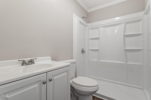 bathroom with a shower, crown molding, vanity, and toilet