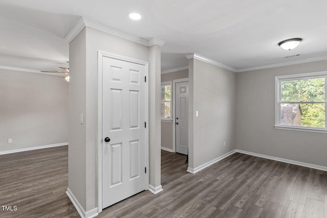 empty room featuring ornamental molding, ceiling fan, and dark wood-type flooring