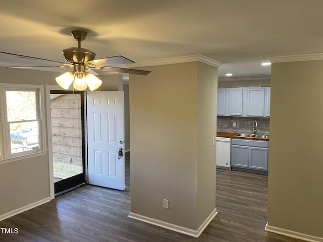 entrance foyer with dark hardwood / wood-style floors, crown molding, and sink