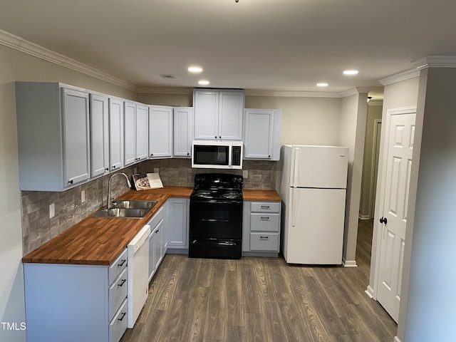 kitchen featuring tasteful backsplash, white appliances, sink, and wooden counters