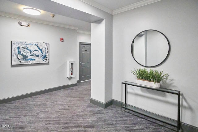 hall featuring ornamental molding and dark carpet