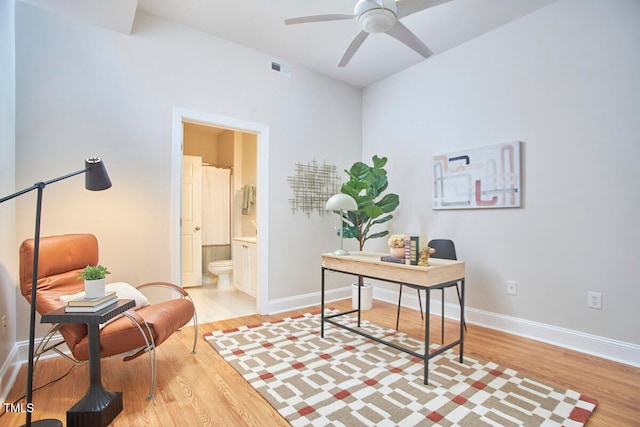 office with light hardwood / wood-style floors and ceiling fan