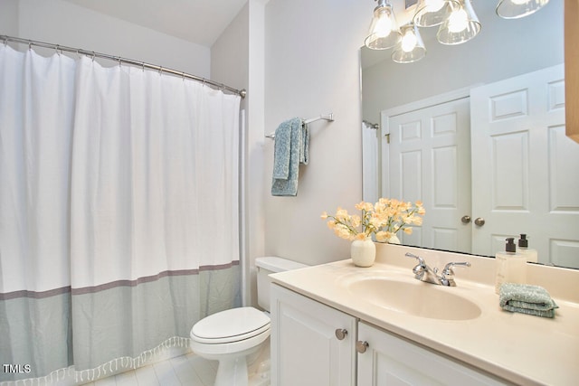 bathroom featuring vanity, tile patterned floors, and toilet