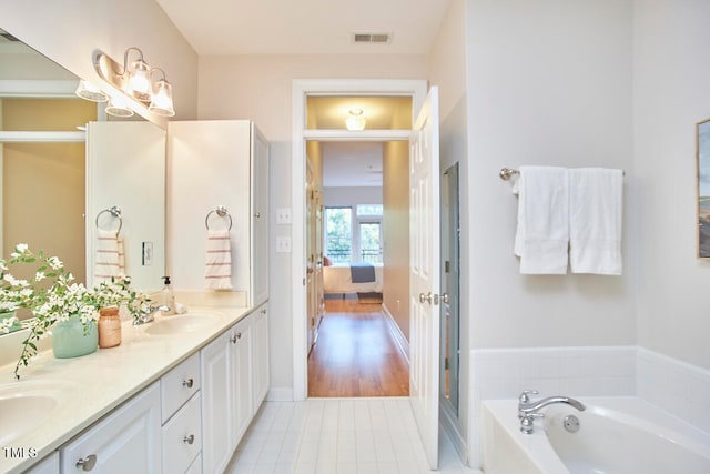 bathroom featuring vanity and a tub to relax in