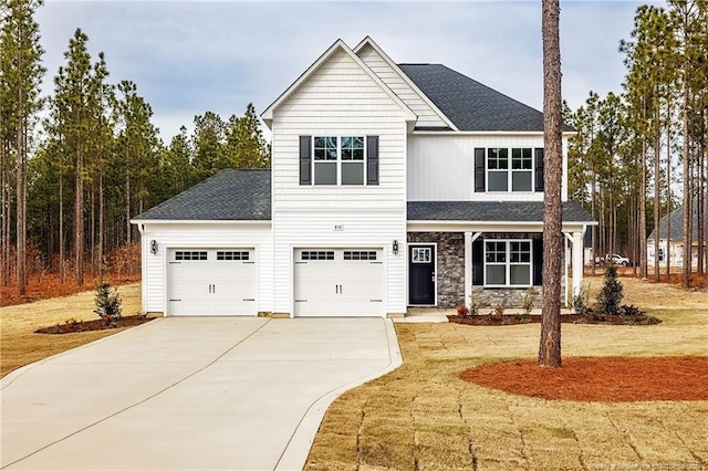 view of front of home featuring a garage and a front yard