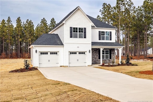 view of front of property with a garage and a front lawn