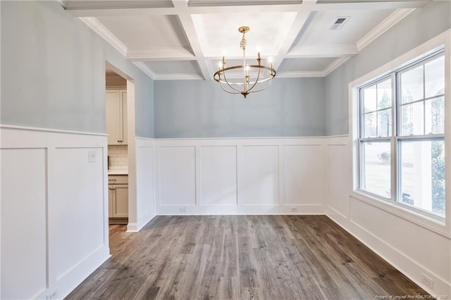 unfurnished dining area with coffered ceiling, hardwood / wood-style floors, beam ceiling, and a notable chandelier