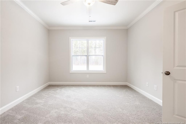 spare room with ceiling fan, ornamental molding, and light carpet