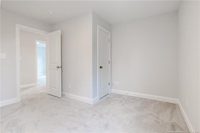 unfurnished room with light colored carpet