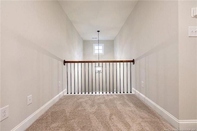 staircase featuring carpet