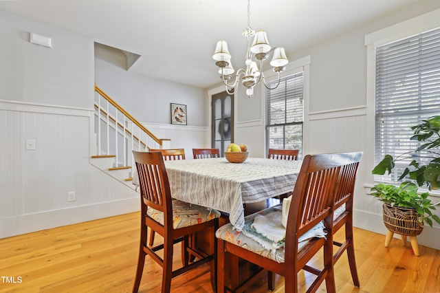 dining room featuring light hardwood / wood-style flooring and a notable chandelier