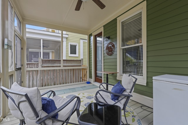 sunroom / solarium with a wealth of natural light and ceiling fan