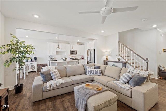 living room with ceiling fan and dark hardwood / wood-style floors