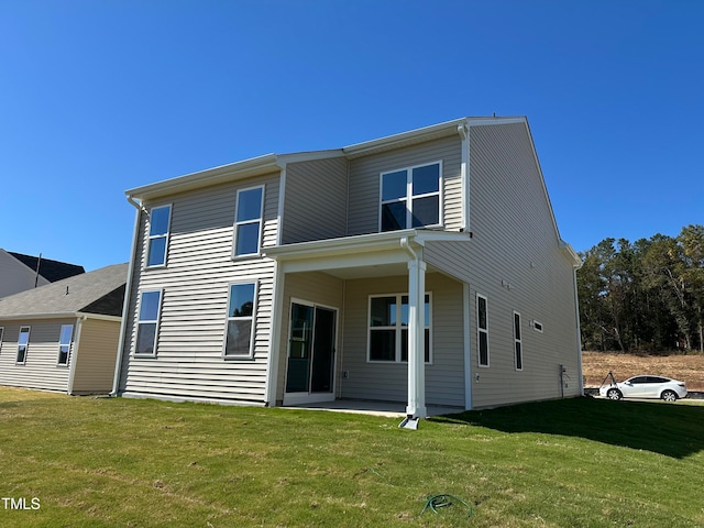 back of house featuring a yard and a patio area