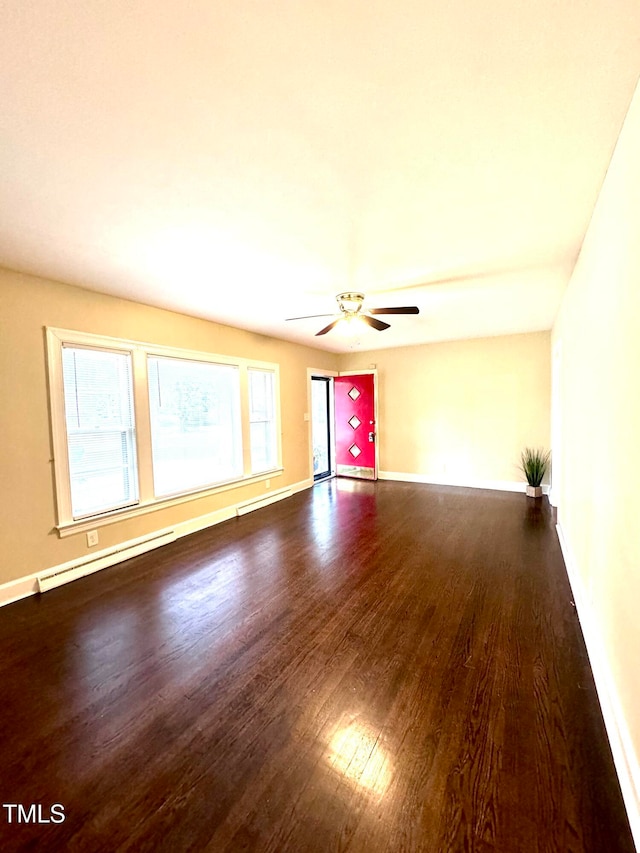 spare room with dark wood-type flooring and ceiling fan