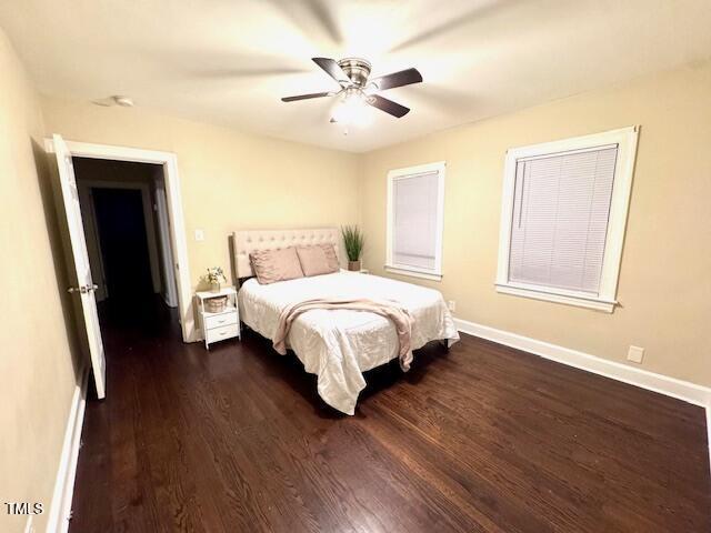 bedroom with dark wood-type flooring and ceiling fan