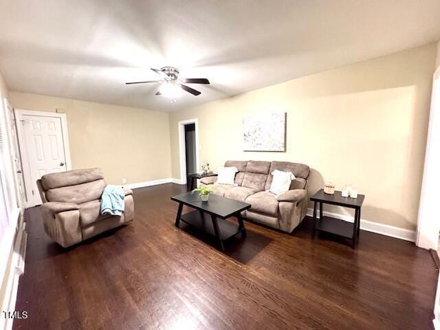 living room with ceiling fan and dark hardwood / wood-style floors