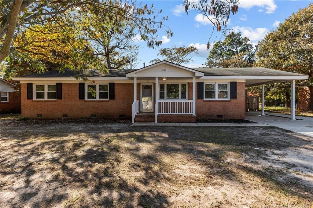 single story home with a carport and a porch