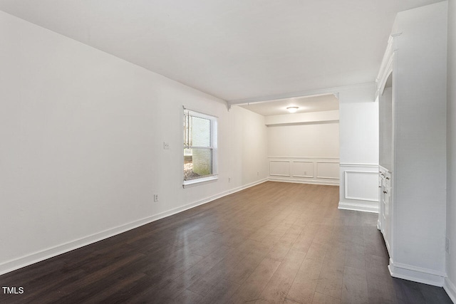 unfurnished room featuring dark wood-type flooring