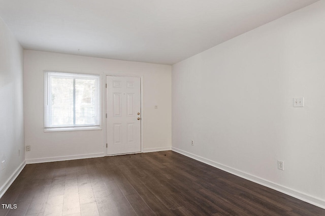 spare room with dark hardwood / wood-style floors