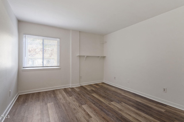 unfurnished room featuring dark hardwood / wood-style floors