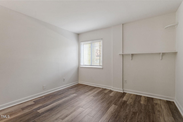 spare room featuring dark hardwood / wood-style flooring