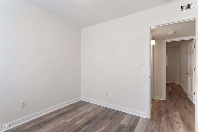 unfurnished room featuring dark hardwood / wood-style floors