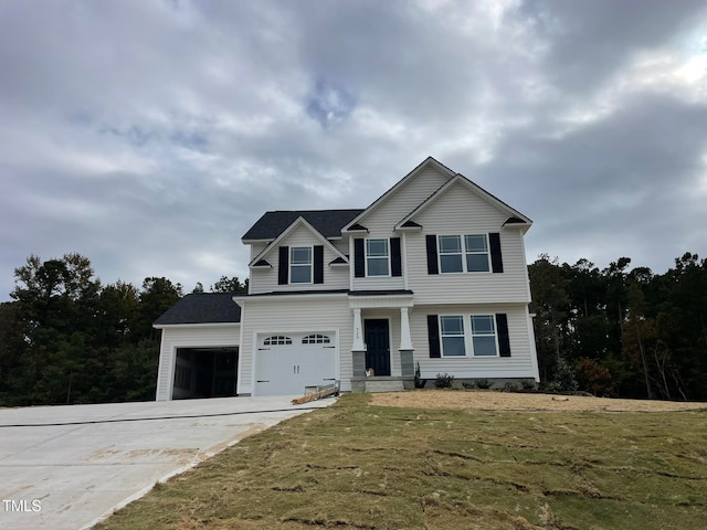 view of front property with a front yard and a garage