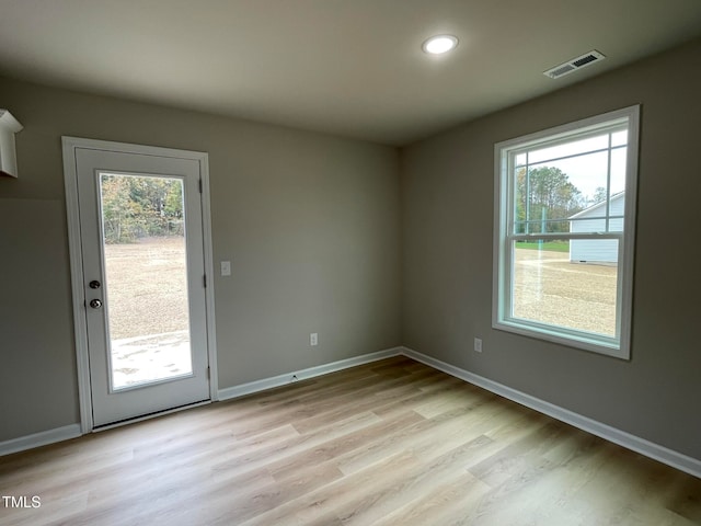 interior space with light hardwood / wood-style floors and a healthy amount of sunlight