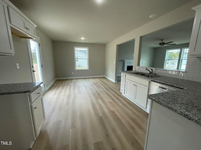 kitchen with white cabinets, a healthy amount of sunlight, and sink