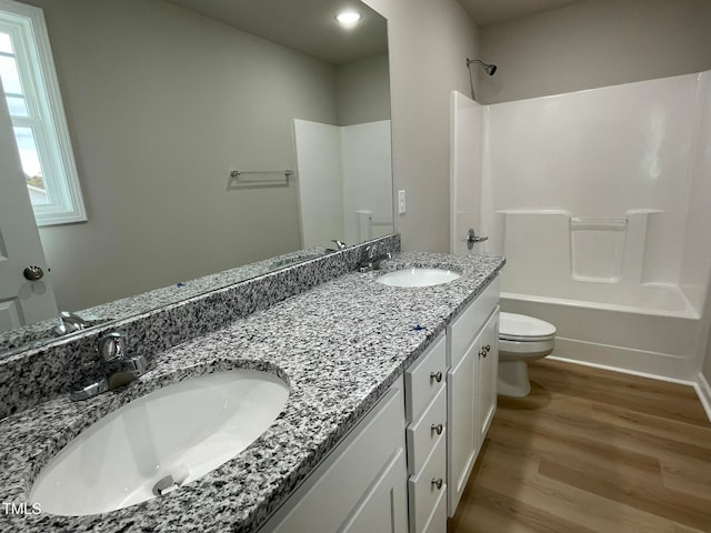 full bathroom featuring toilet, shower / bathing tub combination, vanity, and wood-type flooring