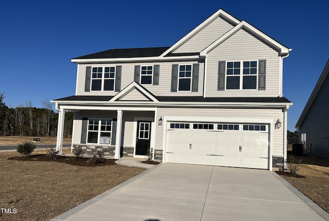 view of front of home with central AC unit, a porch, and a garage