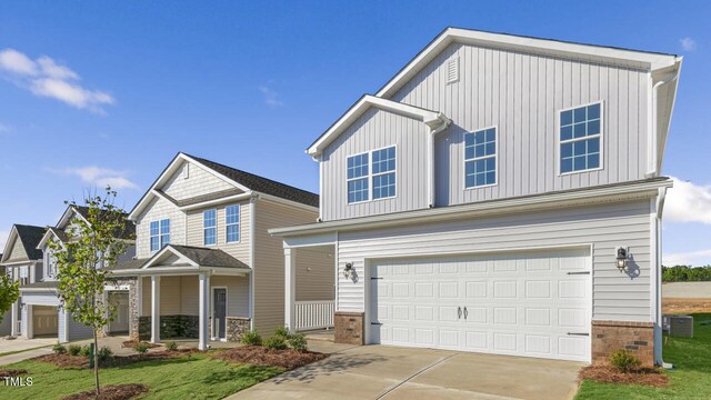 view of front of home with central AC and a garage