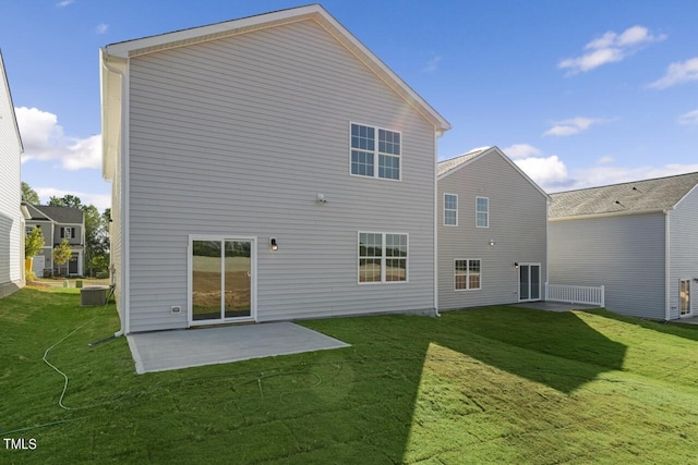 rear view of property featuring a patio area and a lawn