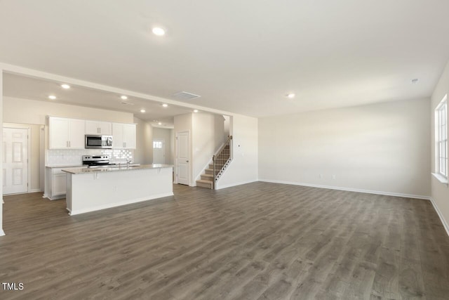 unfurnished living room with dark hardwood / wood-style floors and sink