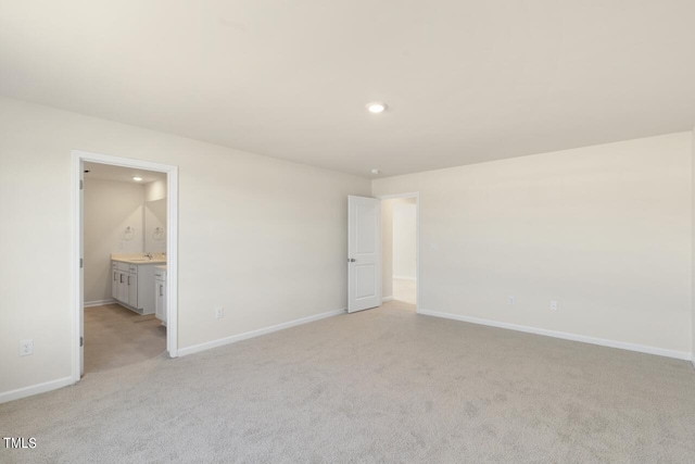 unfurnished room with light colored carpet