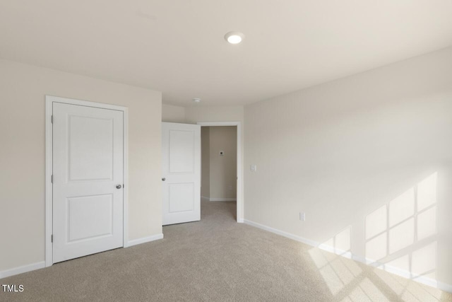 empty room featuring light colored carpet