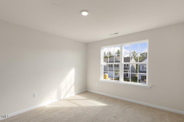 spare room with light colored carpet