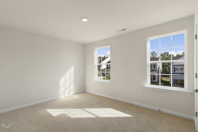 unfurnished room featuring light colored carpet